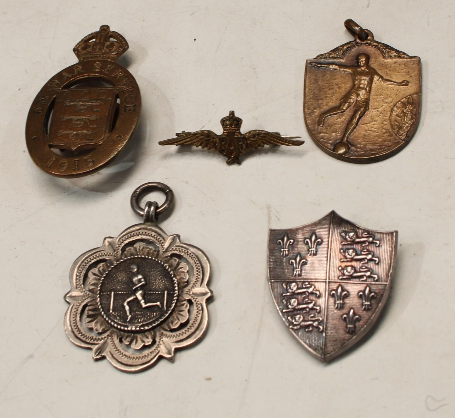 A silver shield shaped brooch with the Royal Arms of England, three lions passant, Birmingham