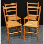 A set of four satinwood bedroom chairs, cane seats. (4)