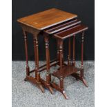 A nest of three early 20th century rectangular mahogany tables, slender turned supports downswept