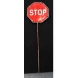 A student trophy, 20th century hand held highway maintenance stop go lollipop, 210cm high