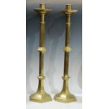 A pair of tall brass hexagonal alter candlesticks, 57.5cm high