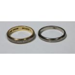 An 18ct gold eternity ring, 4g; an 18ct white gold wedding band, 3.2g (2)