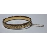 A one-fifth 9ct gold metal core bangle, boxed