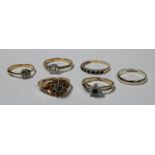 A 9ct gold dress ring, set with diamond chips; three other 9ct gold rings, 8.4g; two fashion
