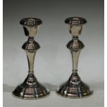 A pair of 20th century filled silver candlesticks, reeded decoration, Birmingham 1977, each 17cm