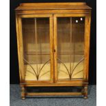 A 20th century oak display cabinet, half gallery above a pair of glazed doors inclosing adjustable