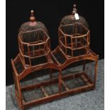 A large architectural style twin domed wooden framed bird cage