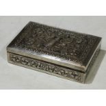 A Cambodian silver rectangular box, hinged cover chased with deity, hardwood lined, 11.5cm long, 900