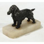 An early 20th century painted model of a spaniel, rectangular alabaster base, 12cm wide c.1920.