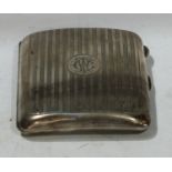 A George V silver cigarette case, engine turned design in vertical bands, circular cartouche with