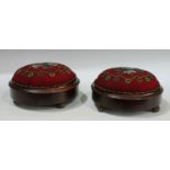 A pair of Victorian circular beadwork footstools, applied with flowers within a geometric border,