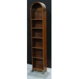 An oak open bookcase, of tall and narrow proportions, domed top, 192cm high, 38.5cm wide, c.1940