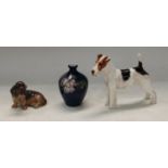 A Royal Doulton model of a terrier, 18cm wide, 14cm high; a Royal Copenhagen model of a Dachshund; a