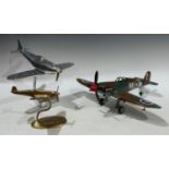 A chrome desk airplane, 32cm x 28cm; another smaller brass airplane, 15cm; a tin plate painted model