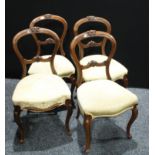 A set of four Victorian mahogany Balloon back dining / salon chairs, stuffed-over upholstery,