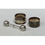 A silver baby's rattle, Birmingham 1904; two silver napkin rings (3)