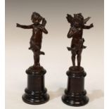 A pair of 19th century bronze figural spill vases, standing with arm raised, high ebonised