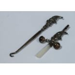 An early 20th century silver novelty baby's rattle, as Mr Punch, whistle terminal, two bells, mother