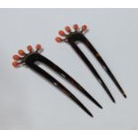 A pair of tortoiseshell style hair combs, each set with five coral beads