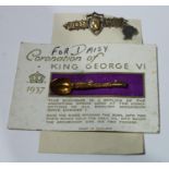 A Victoria 1837-1897 Jubilee silver brooch; a silver young head Victoria stick pin; a Coronation