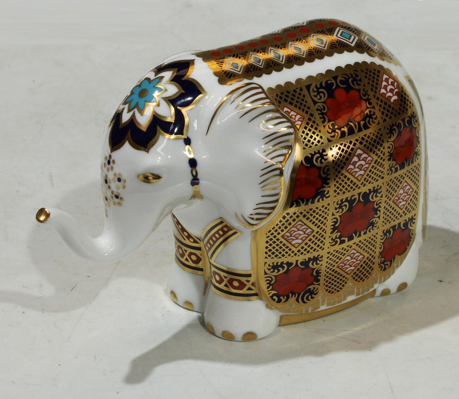 A Royal Crown Derby paperweight, Imari Elephant, raised trunk, gold stopper, 10.5cm high, printed