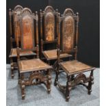 A set of four oak dining chairs, of Spanish baroque design, each tall arced back crested with carved