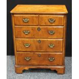 A walnut TV cabinet, quarter veneered rectangular top above a hinged front and a long drawer,