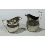 A George III silver helmet shaped cream jug, angular handle, bright-cut engraved with bands of
