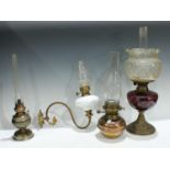 Lighting - a Victorian brass and amethyst glass oil lamp, clear glass floral shade; a single