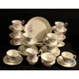 A Royal Albert tea set for six printed with pink rosebuds and blue leaves; a Staffordshire tea set