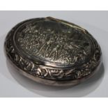 An unmarked white metal oval snuff box, embossed lid with cavaliers