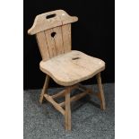 A 19th century Arts and Crafts pine milking chair