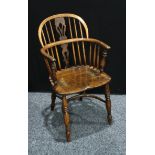 A 19th century oak Windsor elbow chair, low hooped back, shaped and pierced splat, saddle seat,