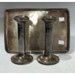 A silver tray of plain design, Chester; a pair of white metal candlesticks (3)