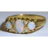 An 18ct gold ring set with three oval opals, size L, 3.5g