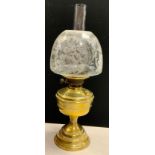 A victorian brass oil lamp with twin duplex burner