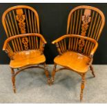 A pair of Elm Windsor chairs, hooped spindle back, pierced and shaped splat, curved arm rail, turned