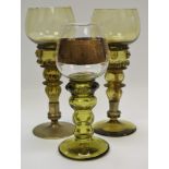 A near pair of 19th century German Hock glasses, green tinted bowls, multi stepped blown hollow