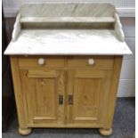 A Victorian pine washstand, marble top and splash back, two drawers above cupboard doors, bun