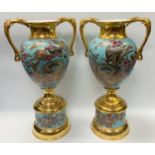 A pair of large late Victorian/Edwardian English pottery twin handled vases and stands, decorated