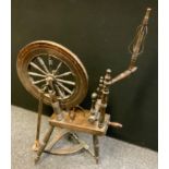 A 19th century dark oak spinning wheel, tapering spokes, shaped peddle rail, turned supports, c.1880