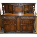 An oak court cupboard single door cupboard to top two carved front short drawers over two door