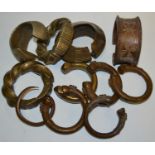 Tribal Jewellery - a Benin style bronze bangle, others similar decorated with assorted geometric