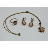 A 9ct gold carved shell cameo suite, comprising ring, pendant and chain, pair of earrings, 6.4g