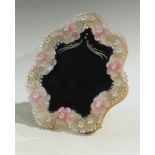 A Murano shaped circular easel mirror, applied with pink flowerheads, on a ribbed clear glass