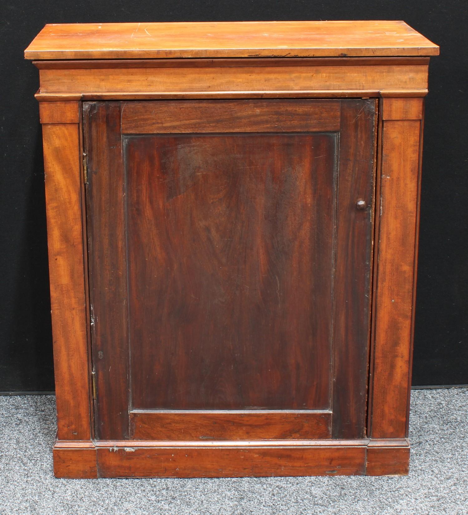 A Victorian mahogany pier book cabinet, panel door enclosing shelves. 100cm high.