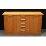 A retro mid-20th century teak sideboard, slightly oversailing rectangular top above a bank of five