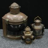 A 19th century ships copper and brass mast head lantern, Port, glass convex lens reflector, carrying