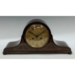 A mahogany arched mantel clock, brass dial, Roman numerals, twin winding holes, Westminster chime,