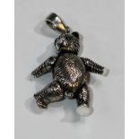 A silver articulated teddy bear pendant